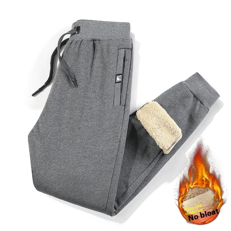 Men's grey fleece-lined oversized cotton track pants with elasticated waistband on a hanger.