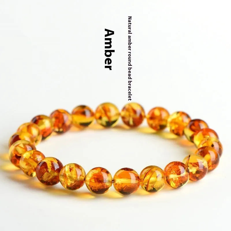 Natural yellow piebald amber bracelet with geometric beads on a wrist.