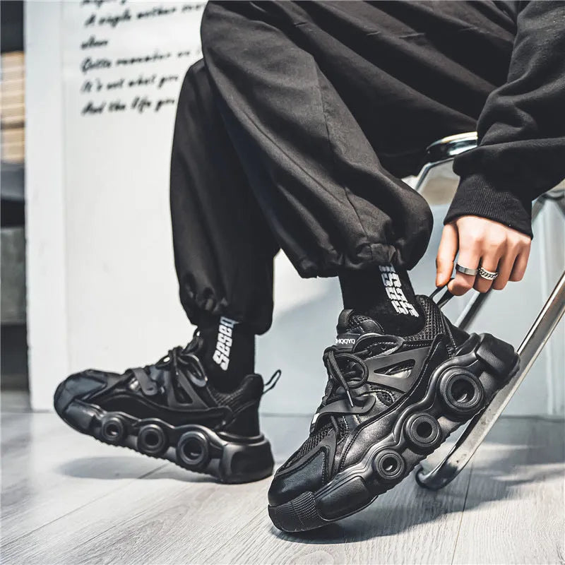 Men's low-top sneakers in black with breathable mesh upper, thick rubber sole, and round toe lace-up design.