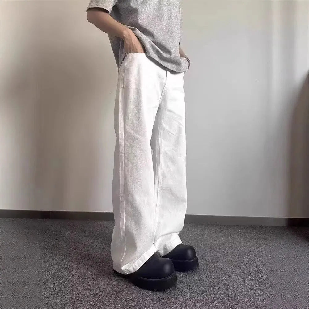 Men's loose straight wide leg white cotton denim jeans on a plain background