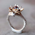 Silver two-tone floral geometric alloy women's ring on a plain background.