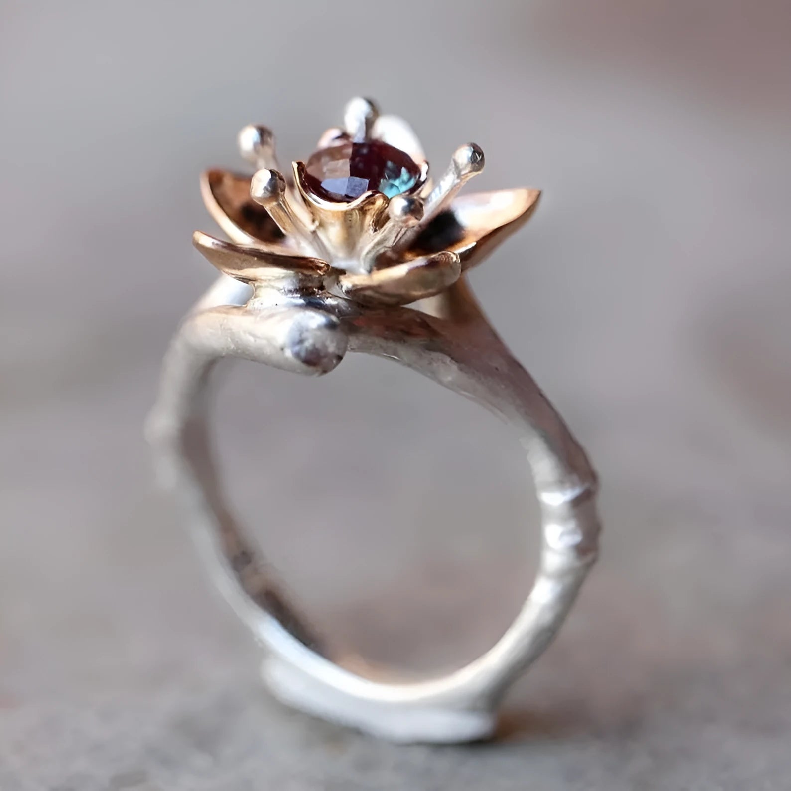 Silver two-tone floral geometric alloy women's ring on a plain background.