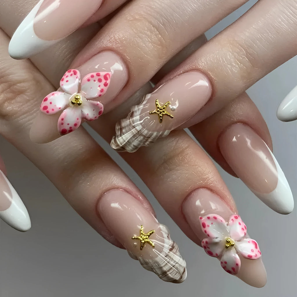 French style false nails with white tips and a black rock pattern patch featuring simple pink and white flowers.