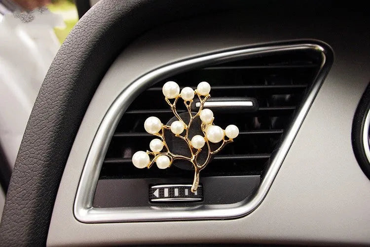 Alloy car fragrance clip with decorative charm attached to car air vent