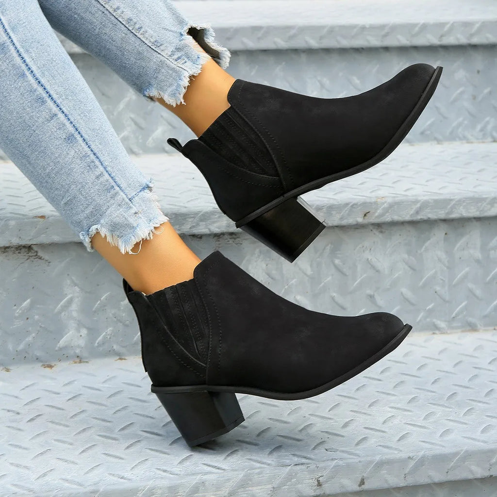 Women's black pointed toe ankle boots with thick square heel, slip-on design