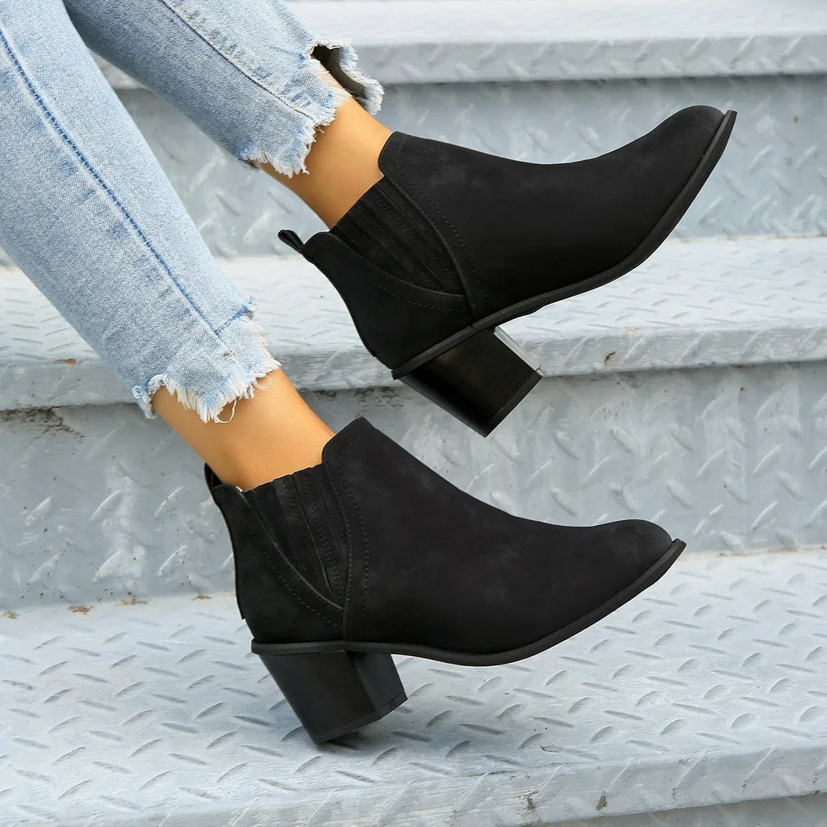 Women's black pointed toe ankle boots with thick square heel, slip-on design