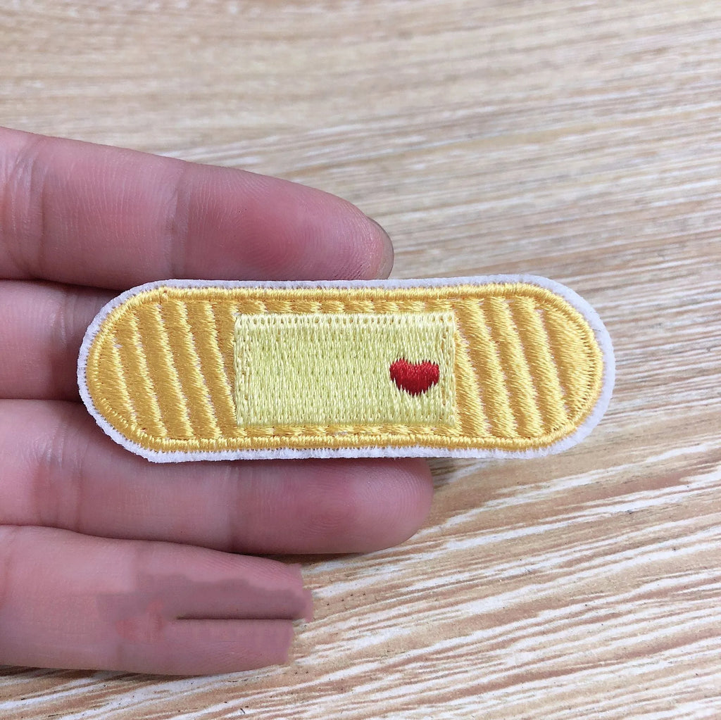 Ten colourful embroidered fabric patches with adhesive backing for clothing decoration