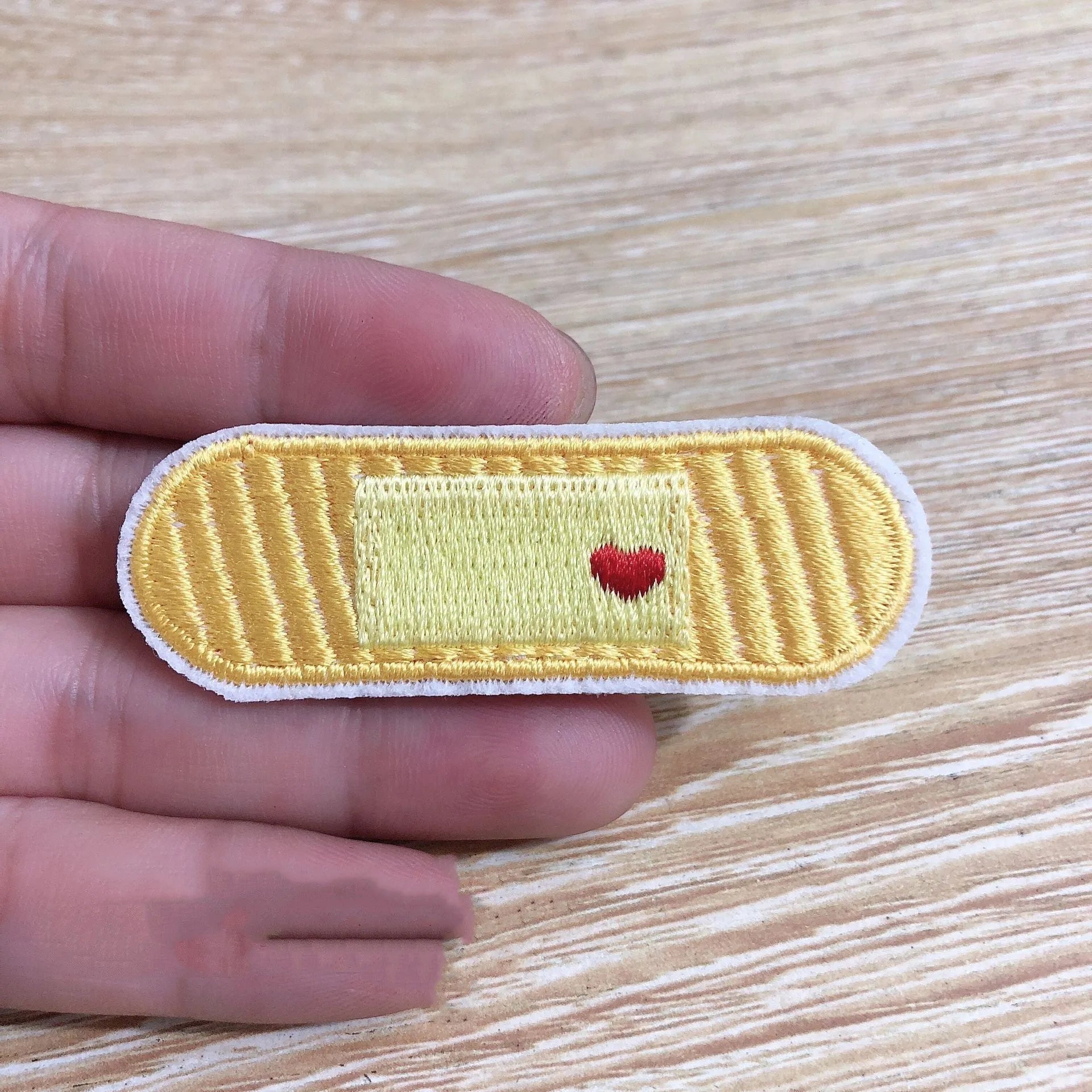 Ten colourful embroidered fabric patches with adhesive backing for clothing decoration
