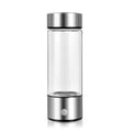 Silver hydrogen water bottle with electric generator, borosilicate glass cylinder.