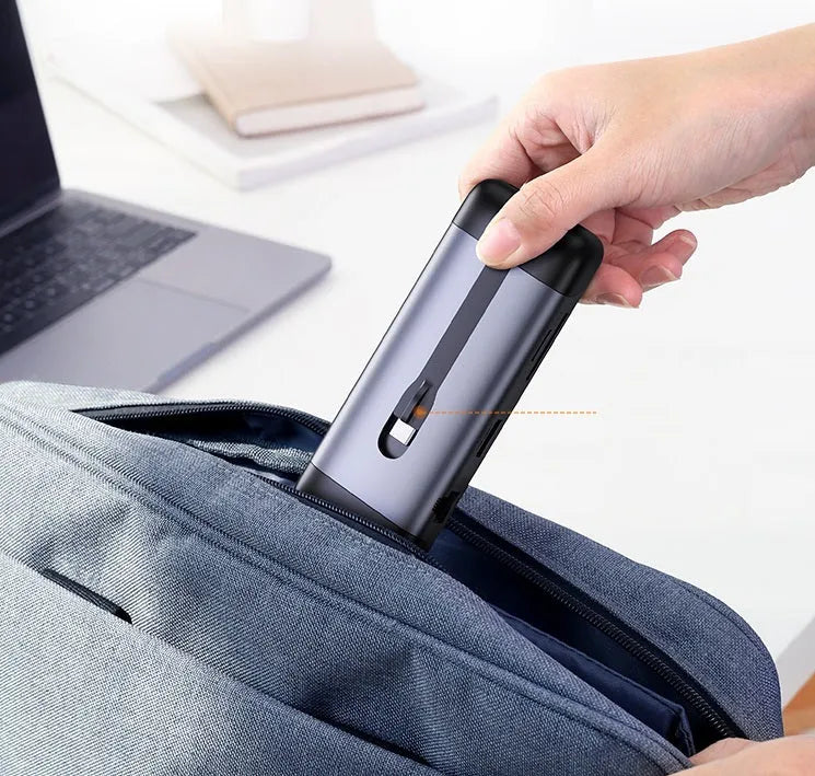 A compact USB-C docking station hub with ports for HDMI, VGA, Ethernet, USB 3.0, and power delivery.
