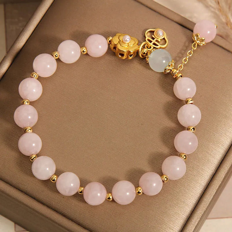 Women's pink crystal flower bracelet with floral pattern design and clasp closure