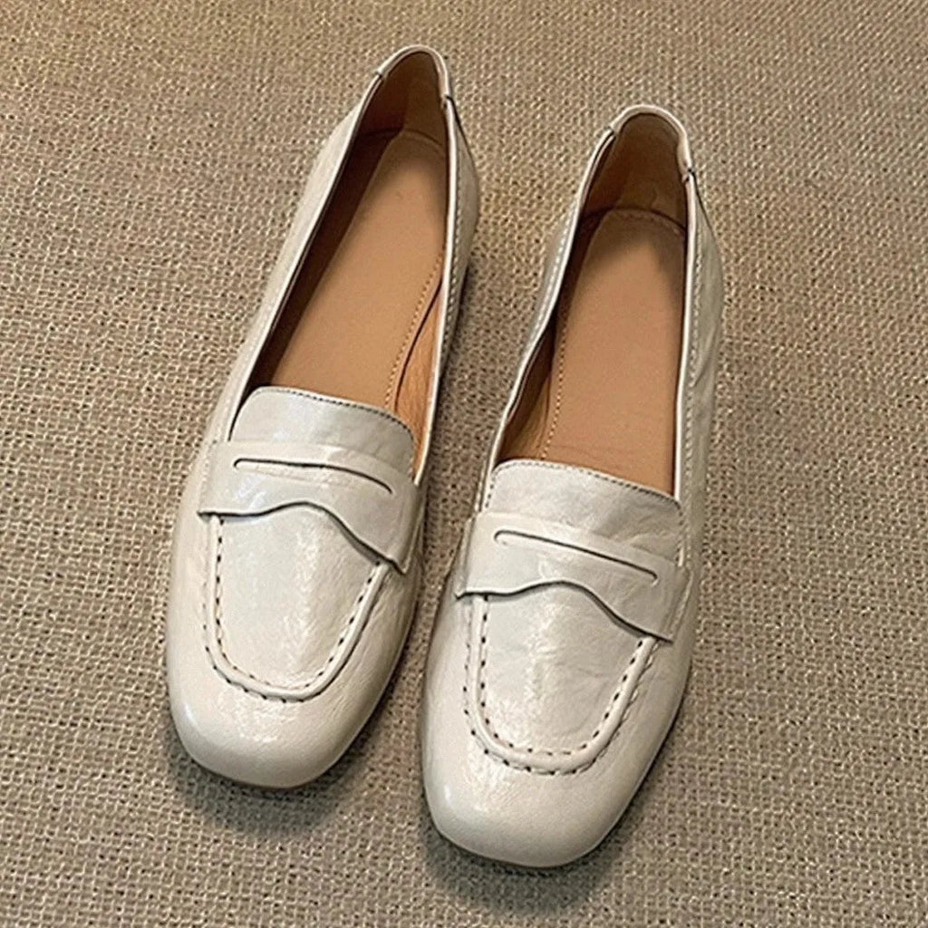 Beige white women's square toe flat shoes with cowhide upper and low heel on a plain background