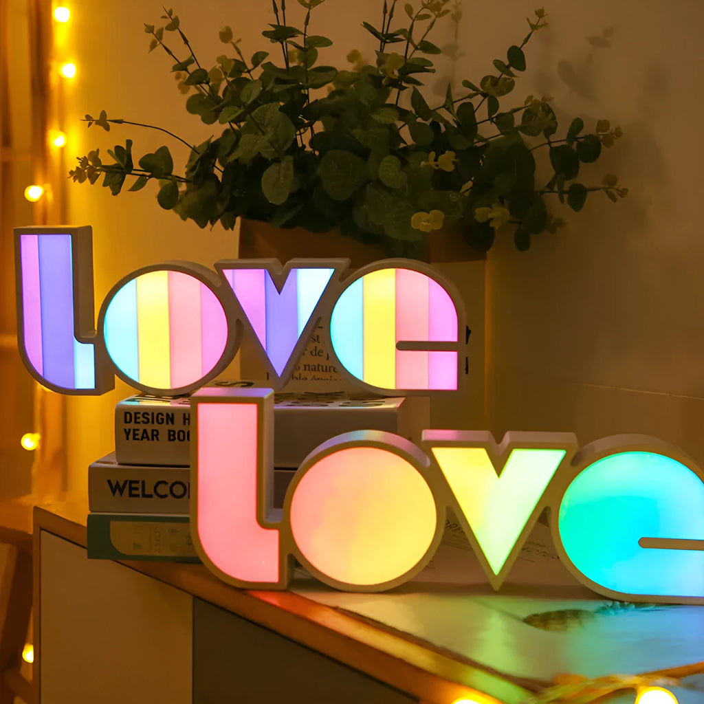 Rainbow style LED Love light for Valentines Day and wedding decoration on a table.