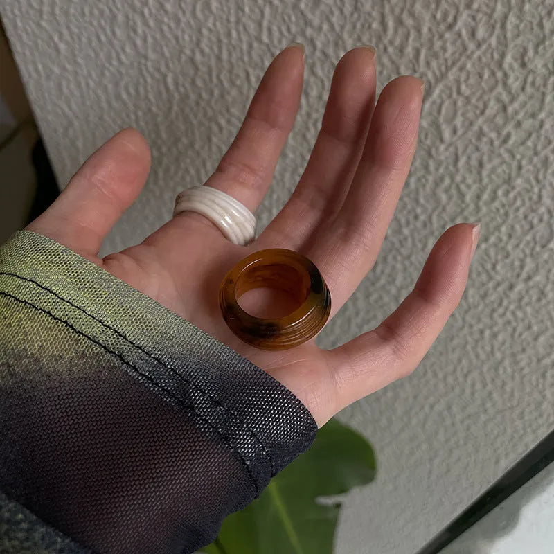 Geometric resin wide ring with irregular Chinese-inspired design in brown and white colours