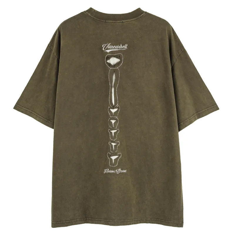 Man modelling a black loose-fit cotton short sleeve top with a white skull and letter graphic print.