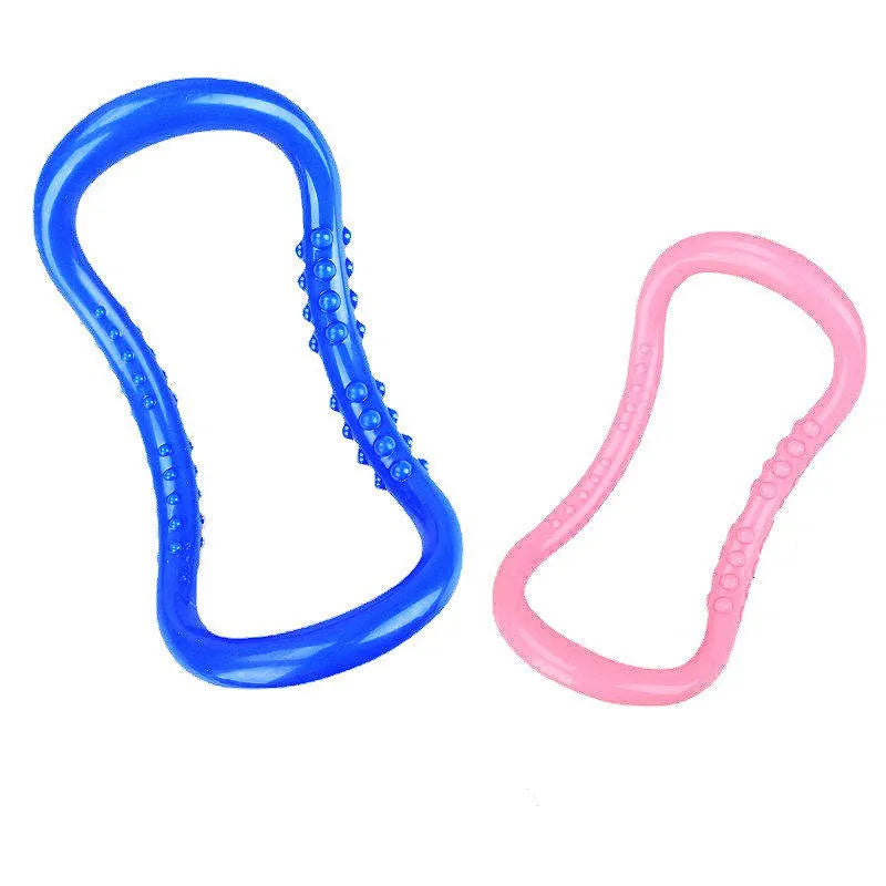 Purple, blue, and pink coloured yoga stretching ring for Pilates and back opening exercises.