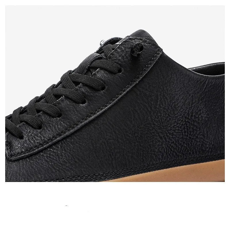 Men's black leather casual shoes with round toe, flat heel, and laced closure on soft rubber sole