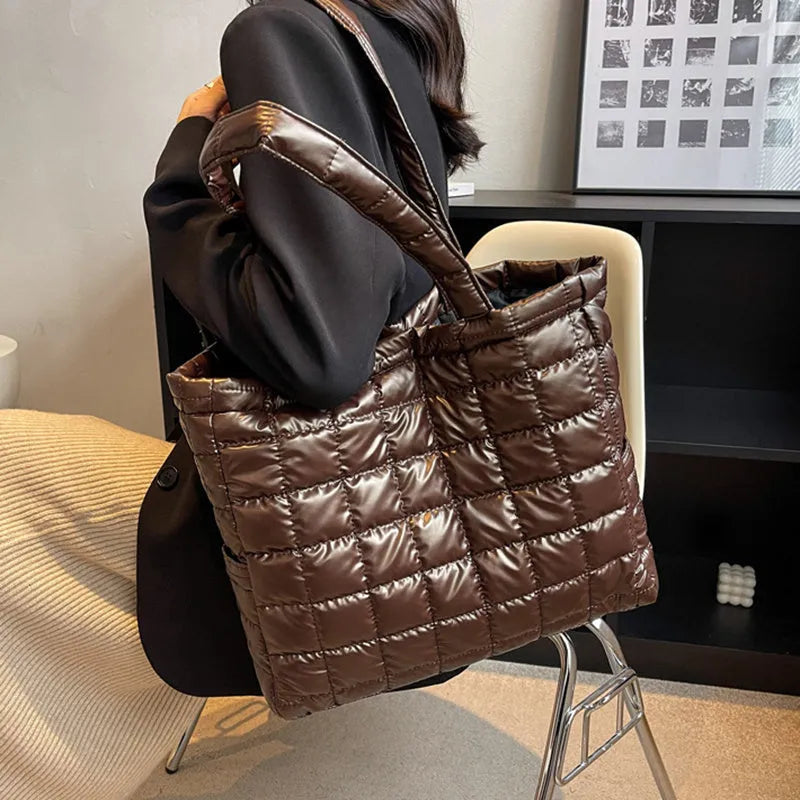 Large nylon plaid bucket shoulder bag in black with rhombus pattern, magnetic buckle, and soft handle.
