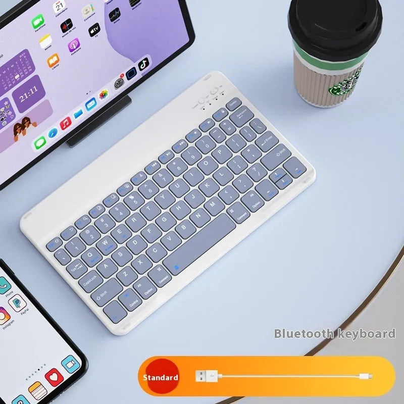 Bluetooth keyboard and rechargeable mouse set for tablet in elegant white on a desk