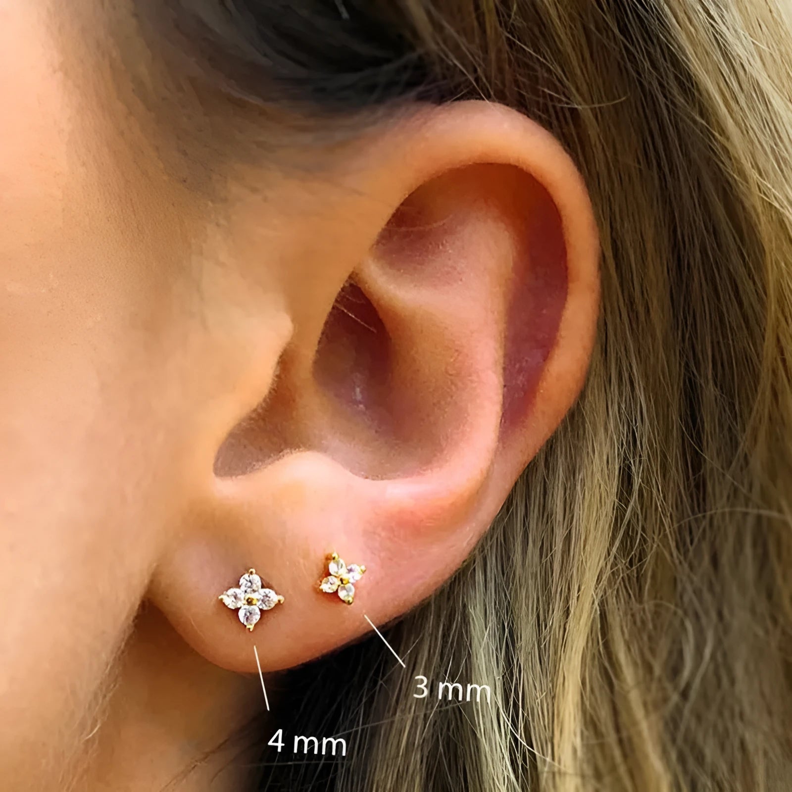S925 sterling silver stud earrings with geometric flower petal and crystal design in gold and platinum finishes.