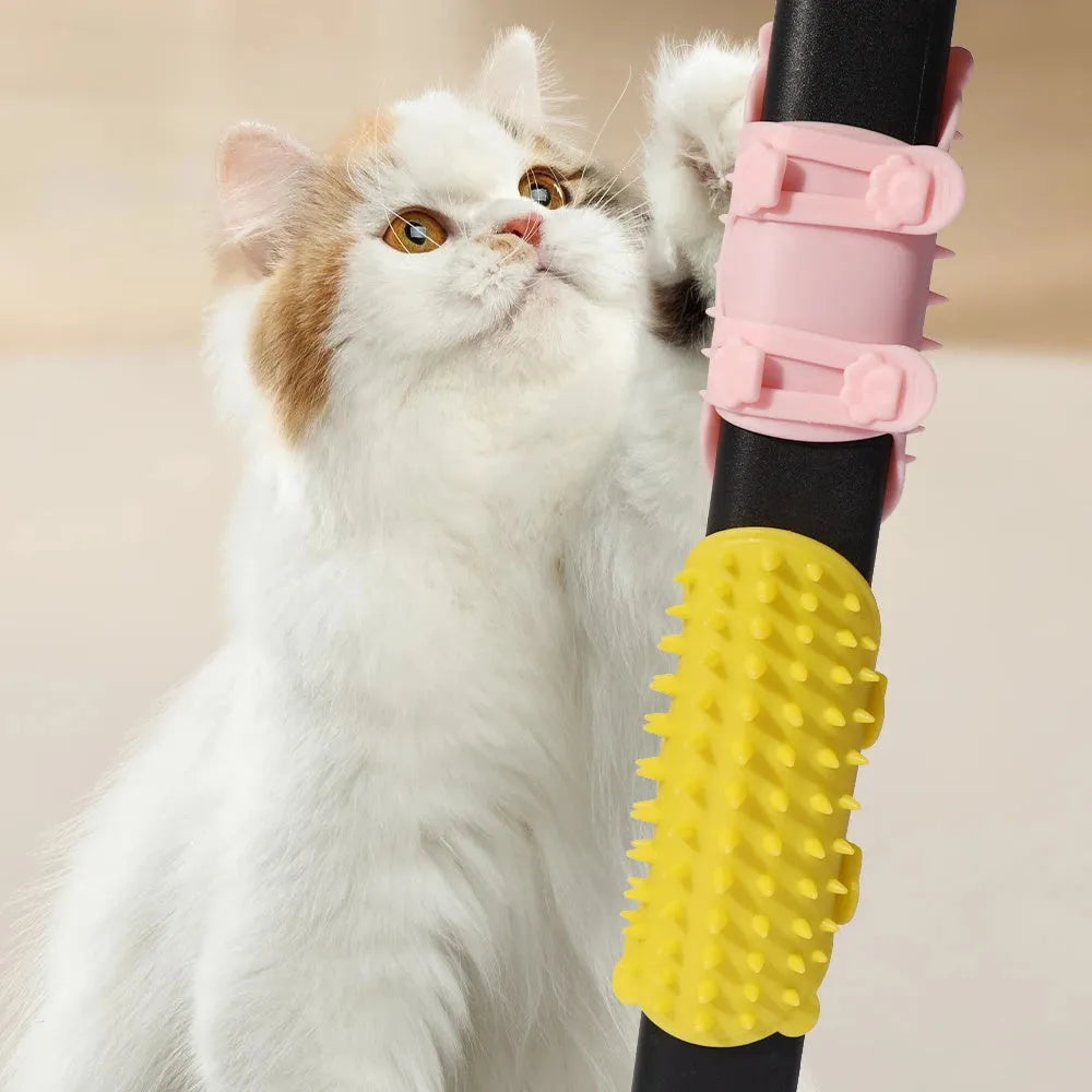 Black silicone cat grooming comb with rounded teeth and adjustable mounting strap for table legs.