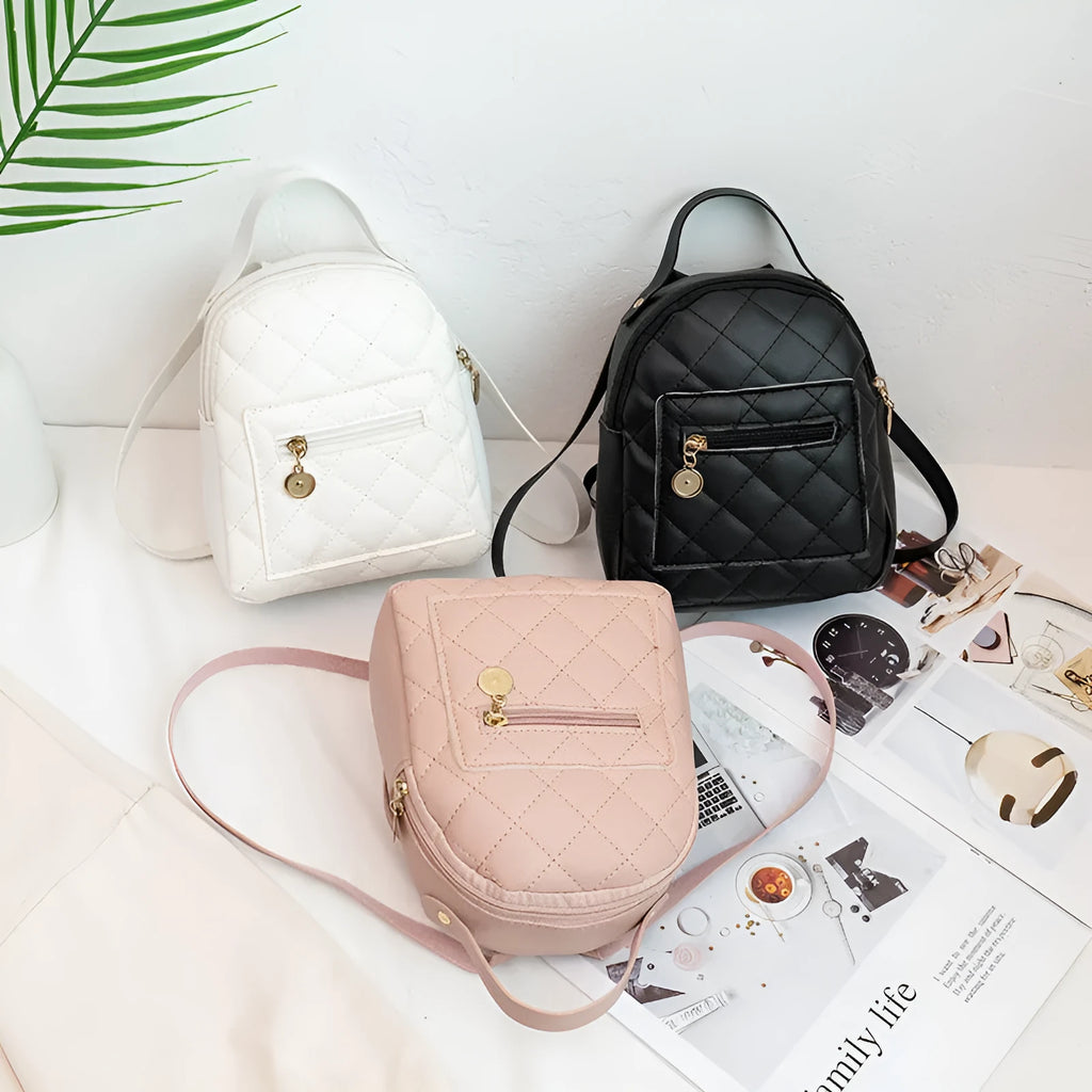 Girls' hard-case embroidered backpack in pink, showing front design and shoulder straps.