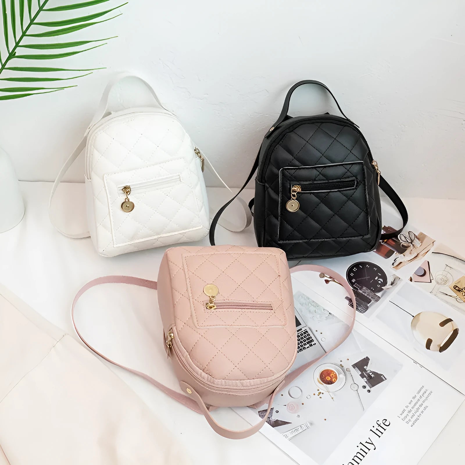 Girls' hard-case embroidered backpack in pink, showing front design and shoulder straps.