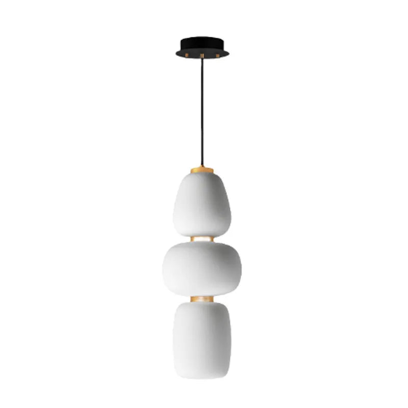 Modern minimalist long chandelier with iron frame and glass elements emitting warm LED light in a living room