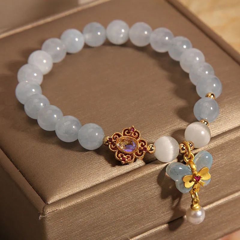 Women's crystal bracelet with a blue aquamarine butterfly pendant and sparkling rhinestone details on an adjustable chain.