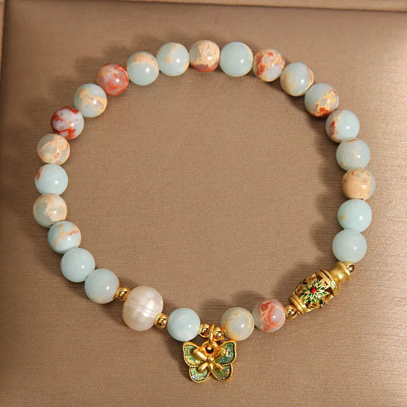 Blue freshwater pearl bracelet with Shoushan stone elements and butterfly pendant.