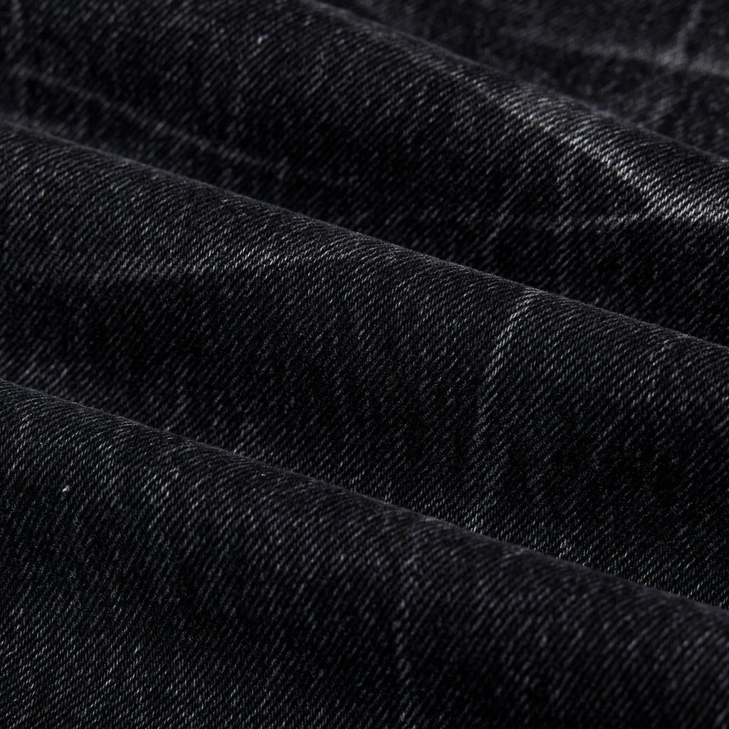 Black men's straight-leg jeans with a distressed lightning crack pattern on the legs.