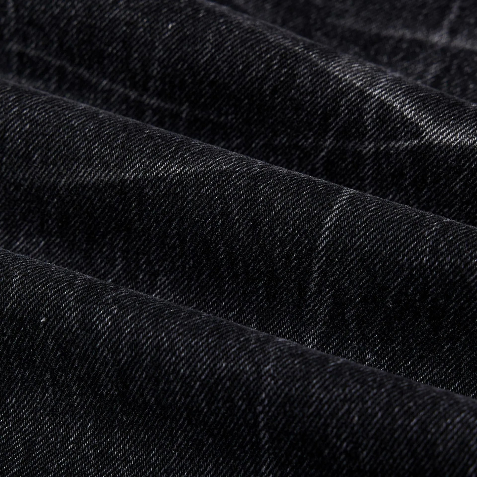 Black men's straight-leg jeans with a distressed lightning crack pattern on the legs.