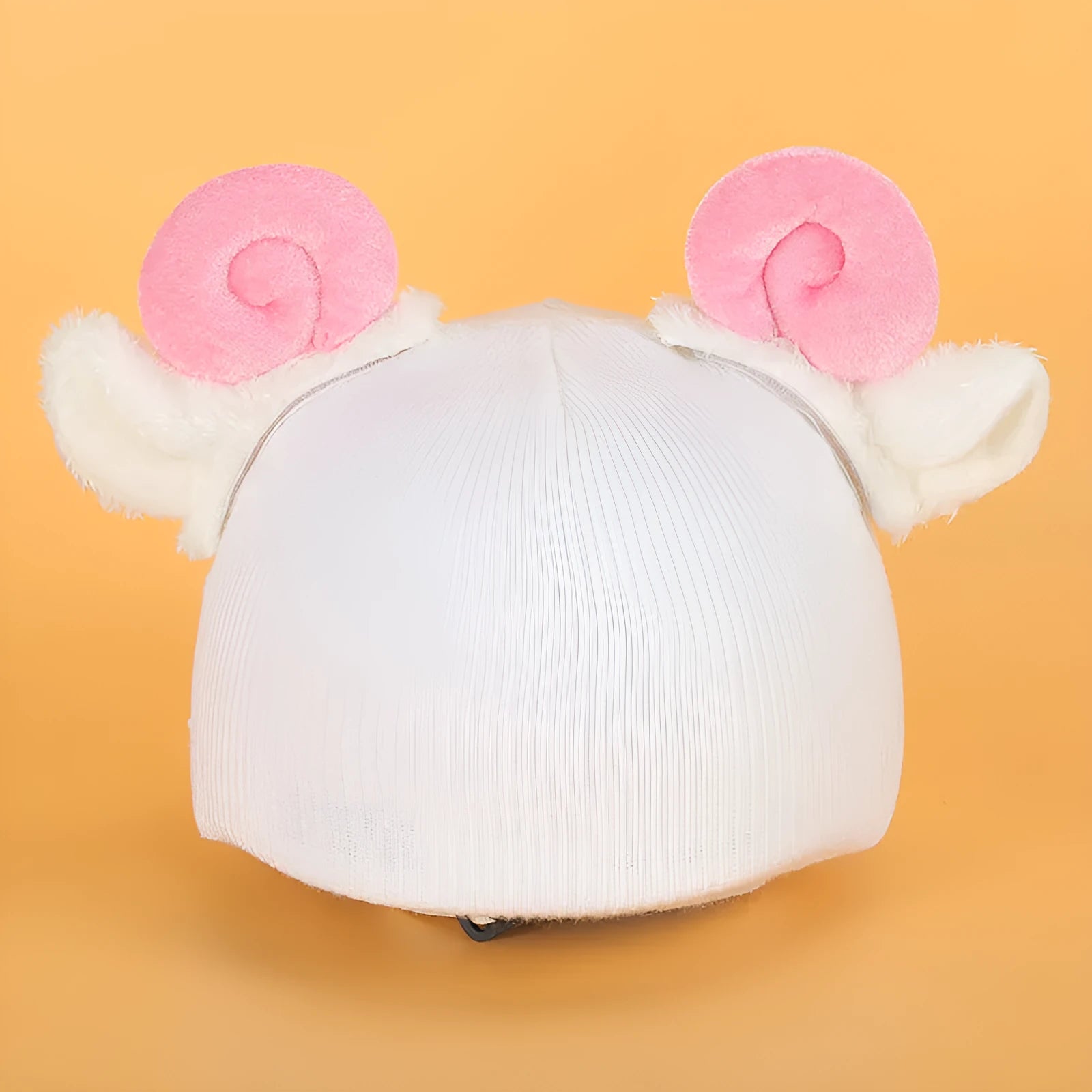 Soft plush cartoon character cover on a motorcycle helmet, showing size M and decorative ear sections.