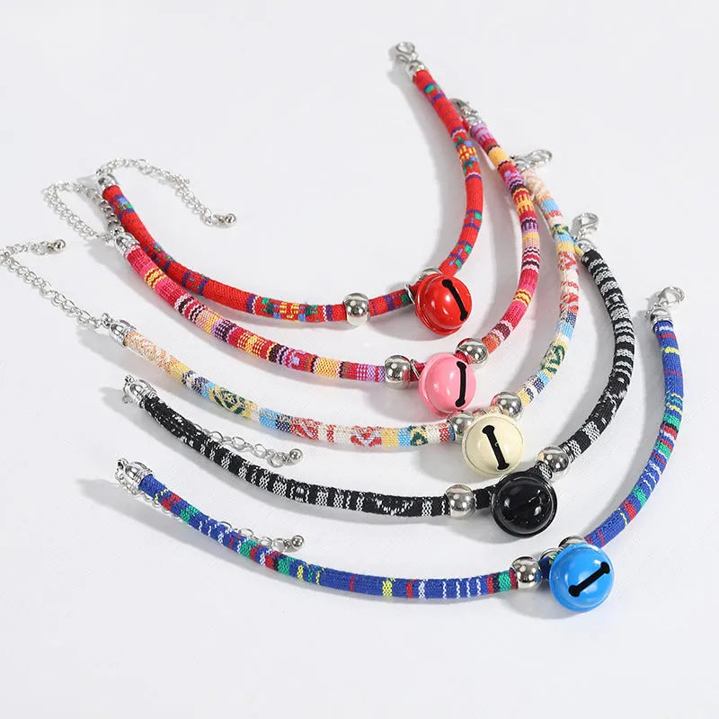 Coloured adjustable pet collar with a metal bell and buckle in ethnic style for dogs and cats.