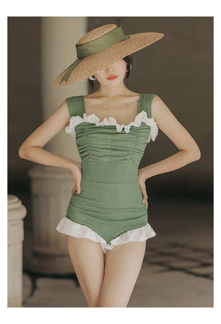 Black high-waisted one-piece swimsuit on a mannequin, showing quick-dry fabric and slimming cut.