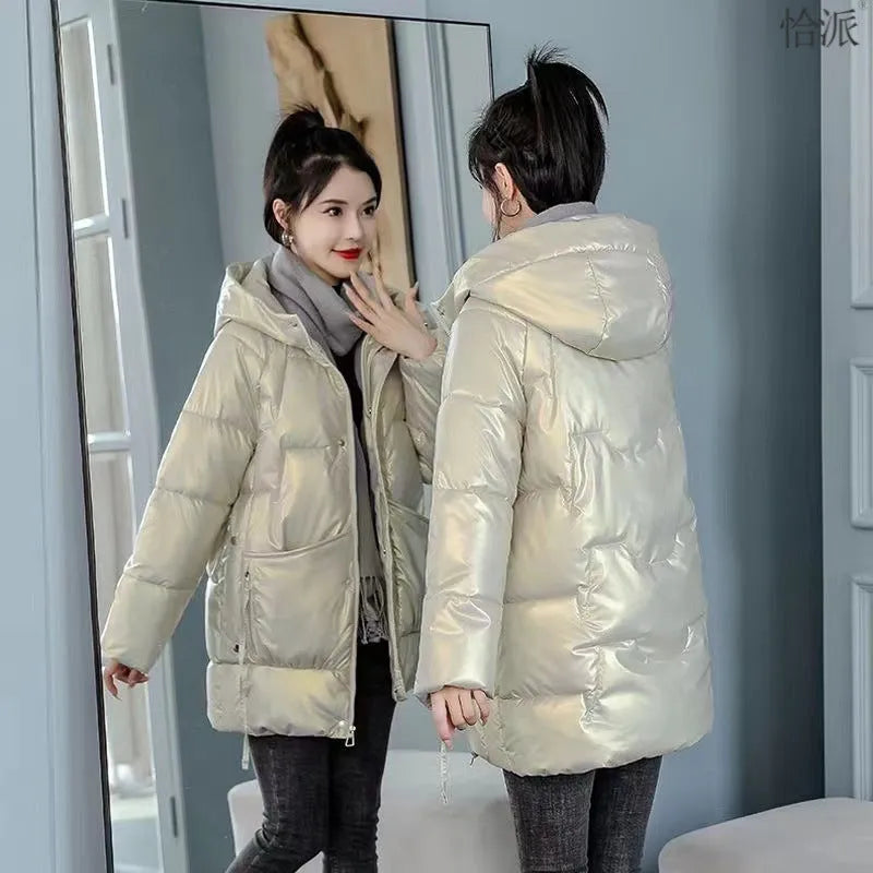 Green loose thick hooded women's winter jacket on a hanger, showing long sleeves and front zip.