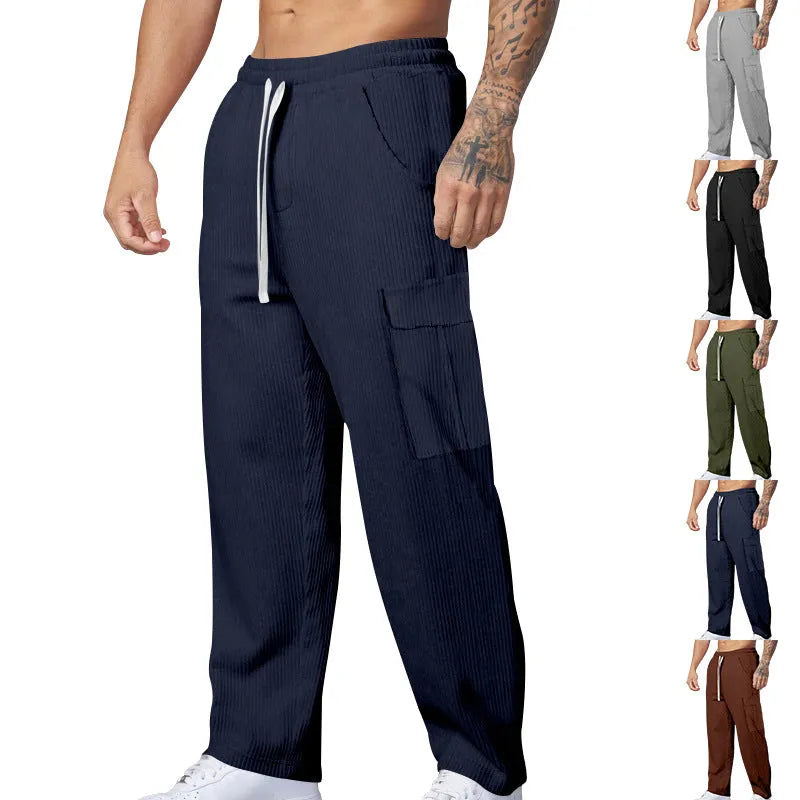 Men's navy blue corduroy cargo trousers with loose fit and straight legs on a hanger.
