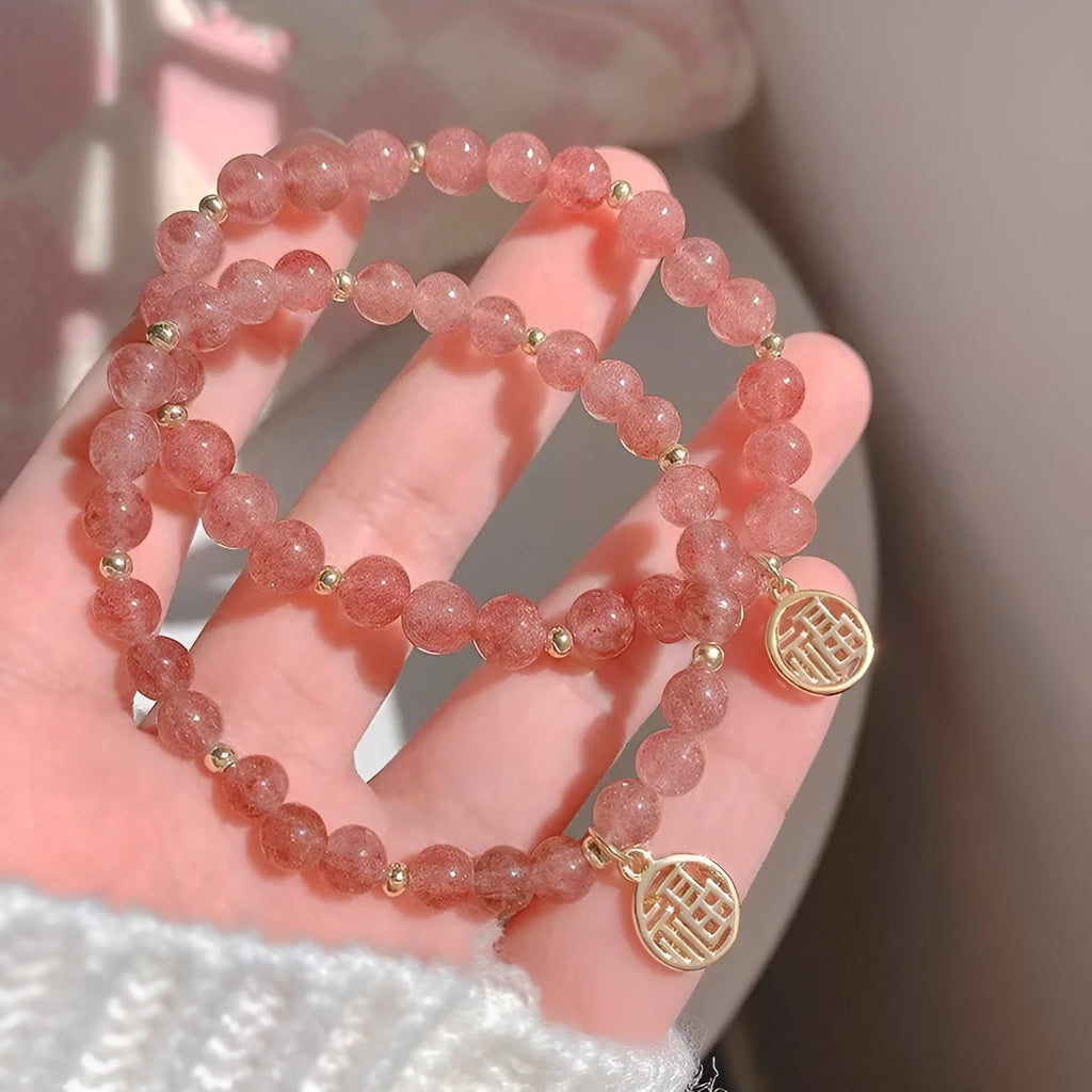 Women's strawberry quartz blessing card bracelet with glass construction and universal wrist size