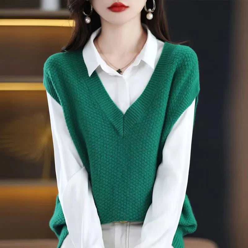 Creamy-white V-neck sleeveless knitted vest with a raised 3D pattern texture on a hanger.