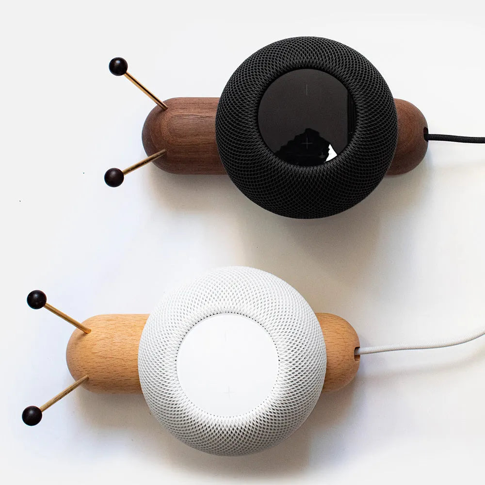 Coffee coloured non-slip desktop bracket for Apple HomePod speaker.