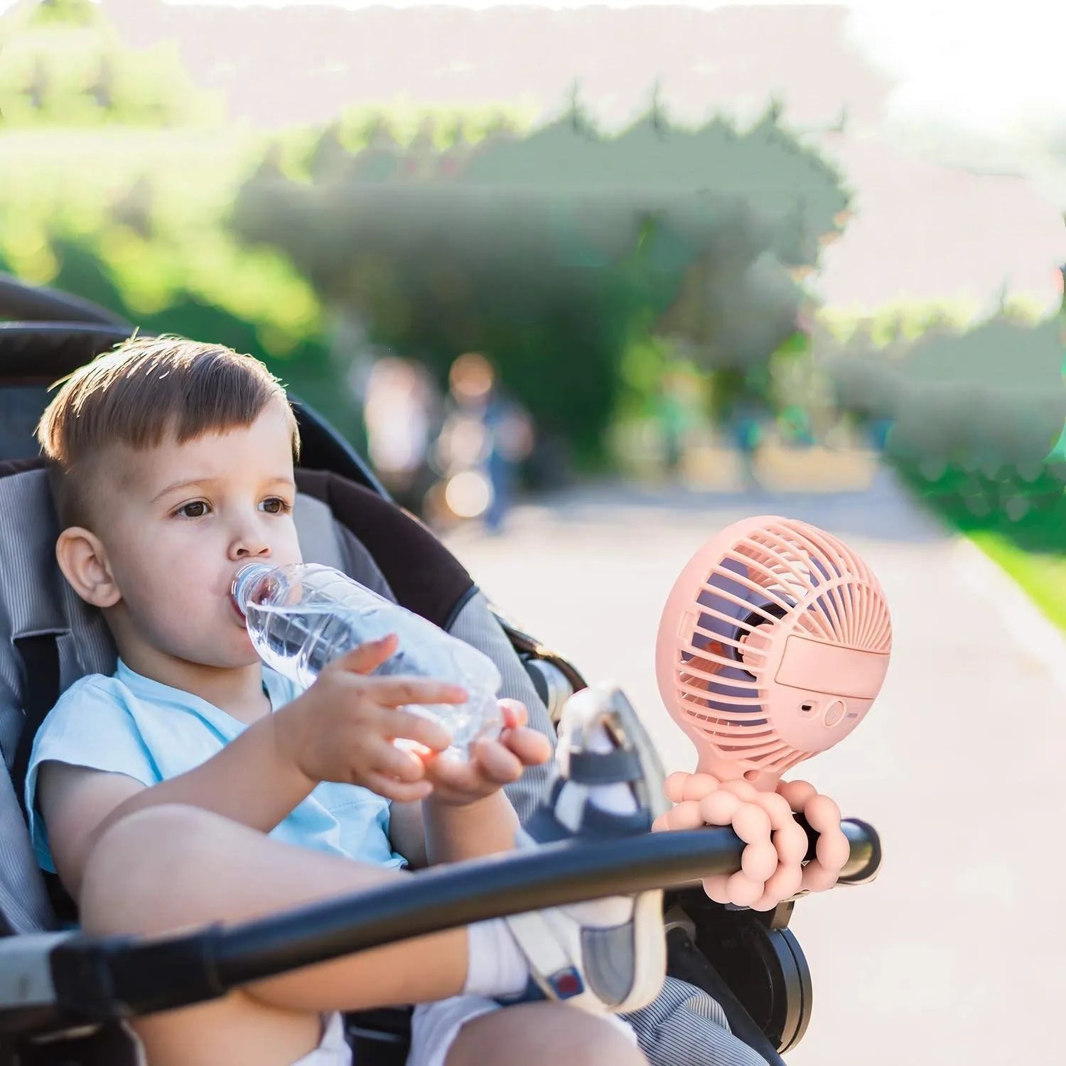 Pink USB rechargeable octopus stroller fan with flexible legs attached to a baby pushchair