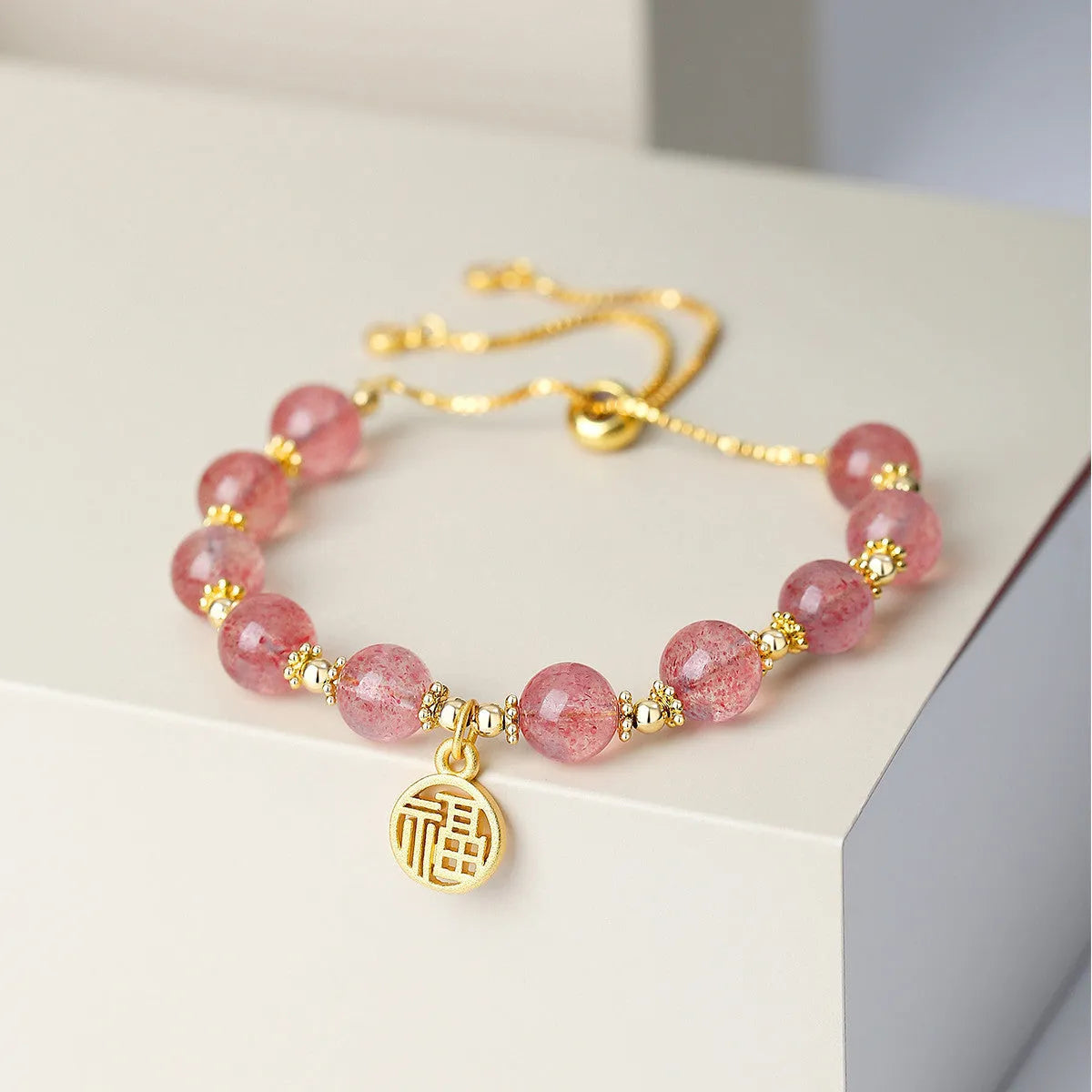 Pink strawberry quartz geometric bracelet with electroplated finish and fu character detail