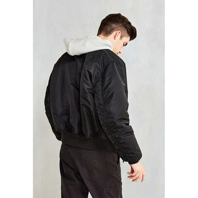 Men's reversible nylon pilot jacket in army green, shown on a model, displaying its loose fit and double-sided design.