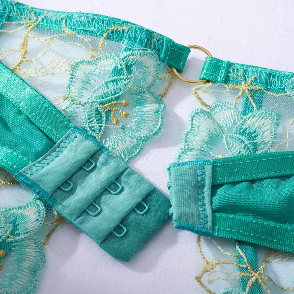 Light green women's embroidered bra and matching briefs set on a white background.