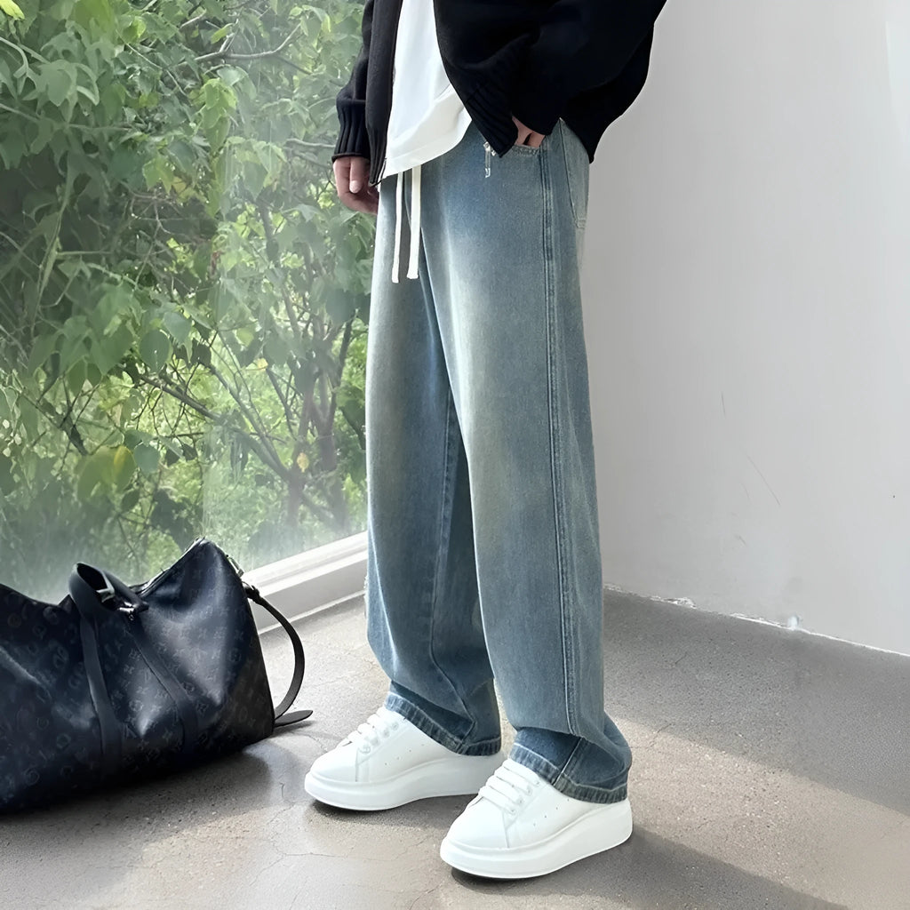 Blue straight-leg men's trousers with drawstring waist and cotton denim fabric