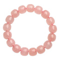 Natural crystal barrel bead bracelet with pink geometry beads measuring 8-10mm