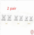 S925 sterling silver stud earrings with geometric flower petal and crystal design in gold and platinum finishes.