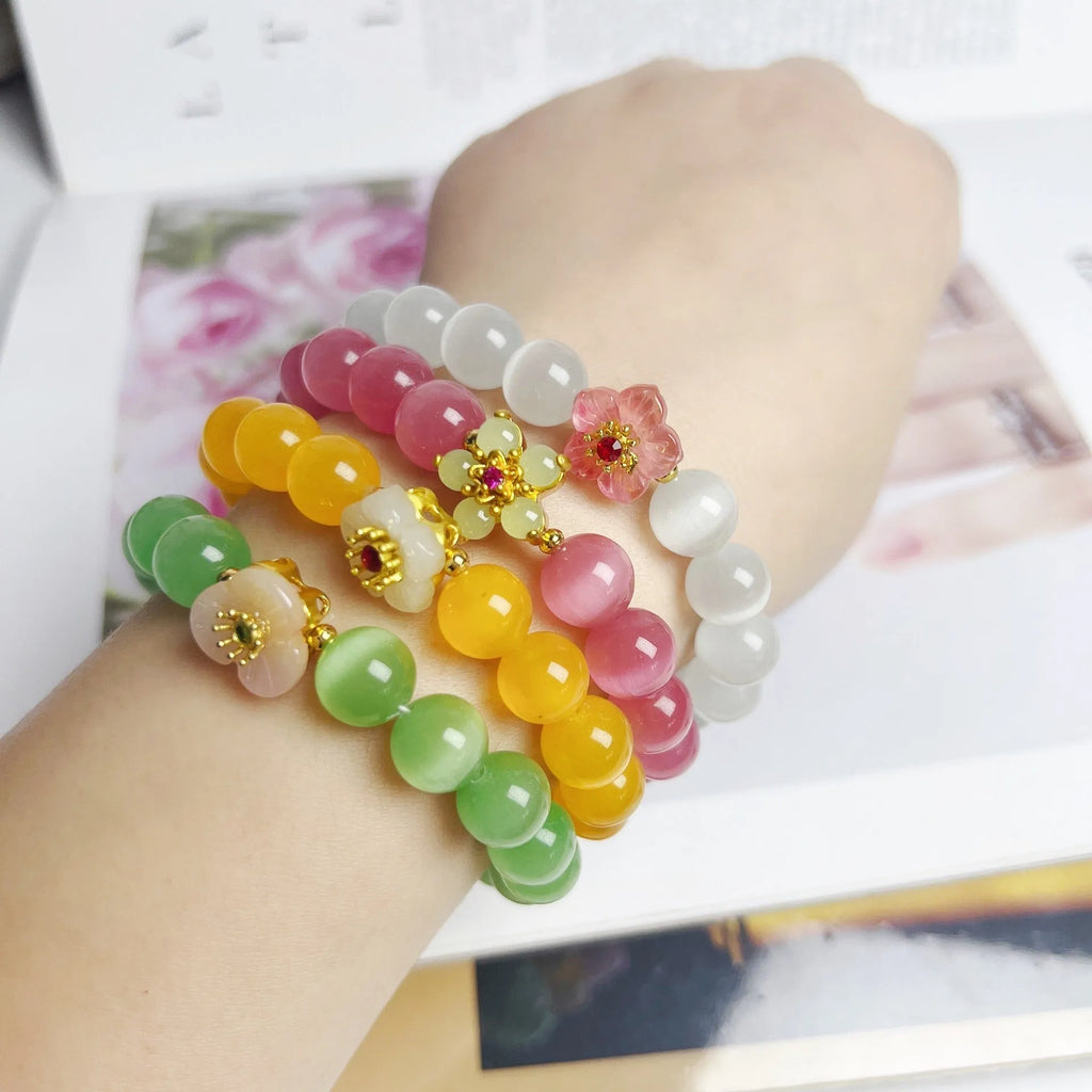 Handmade glass bead bracelet with floral design in yellow, pink, white, or green.