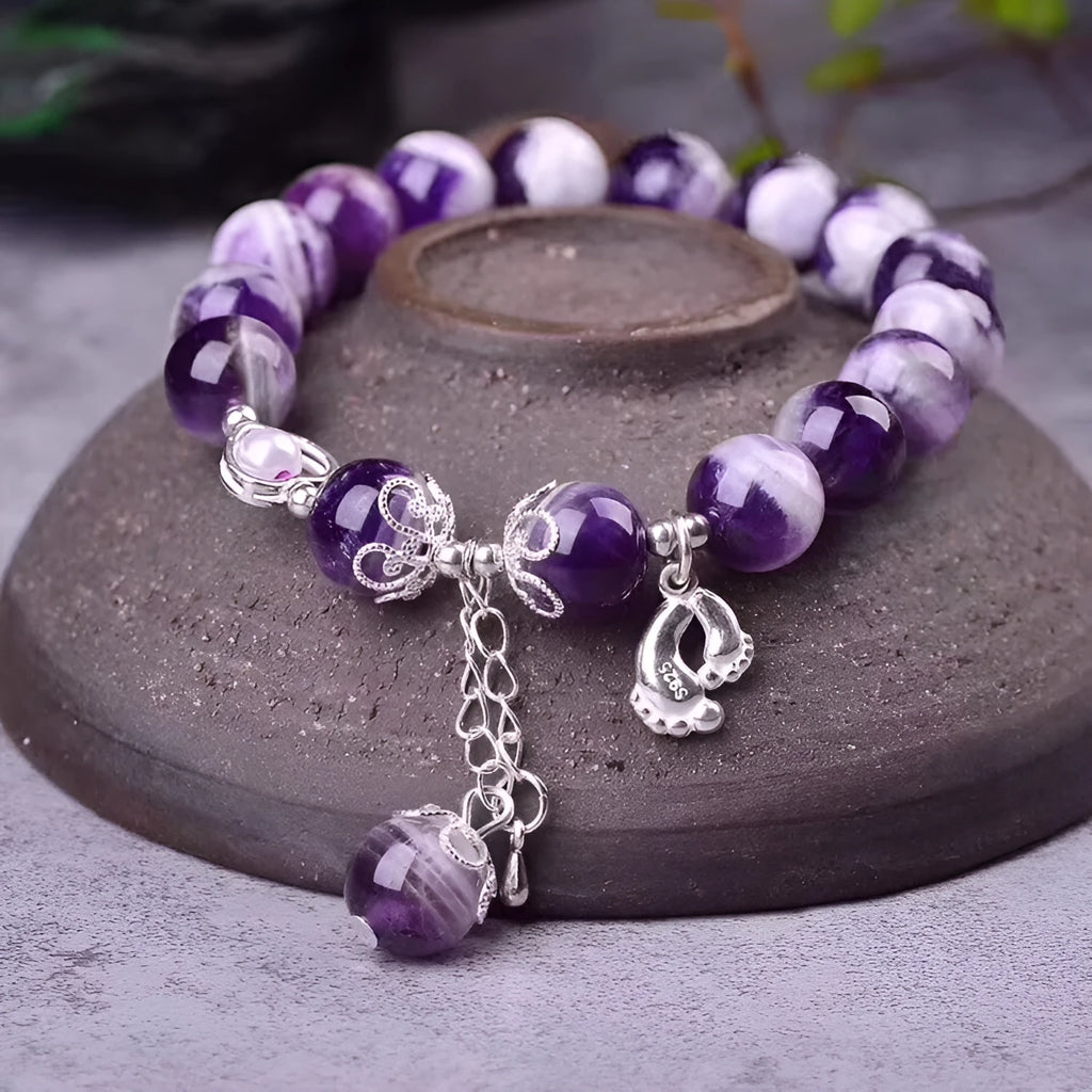 Amethyst bracelet for women with 10mm round beads on a wrist.