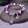 Amethyst bracelet for women with 10mm round beads on a wrist.